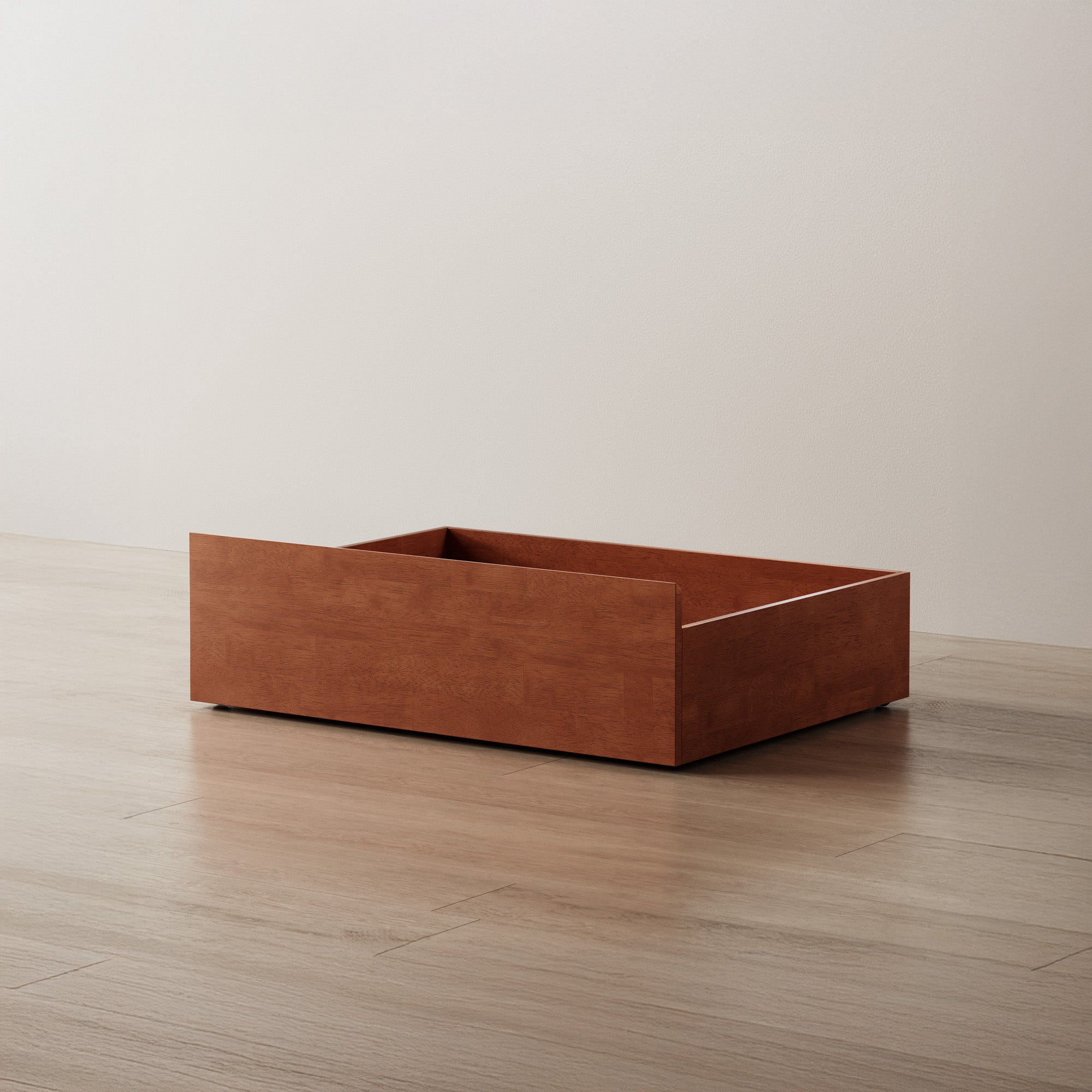 Wooden planter box on a wooden floor with a plain background